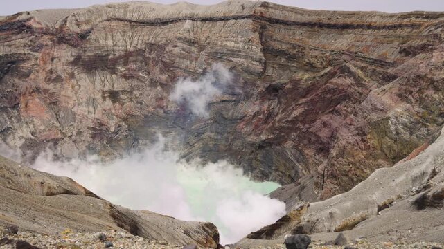 Mount Aso Nakadake volcano crater, Aso-San, caldera, Aso-Kuju National Park hiking, Kyushu island region, Kumamoto prefecture, Japan, eruption with steam and smoke, volcanic desert landscape view