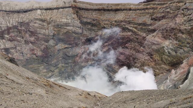 Mount Aso Nakadake volcano crater, Aso-San, caldera, Aso-Kuju National Park hiking, Kyushu island region, Kumamoto prefecture, Japan, eruption with steam and smoke, volcanic desert landscape view