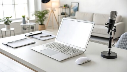 Modern home office setup with laptop and microphone on white desk