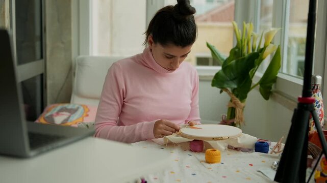 Detailed shot of artisan woman engaging in stitching task
