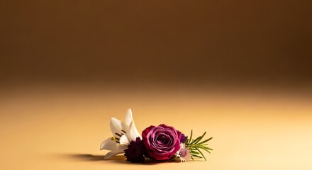 A beautiful and delicate floral arrangement of a white lily, deep purple rose, and small accent flowers, elegantly placed on a light brown surface with a warm, gradient background