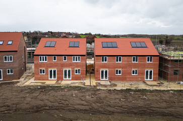 Affordable new build homes with eco friendly solar panels on a construction site in the UK