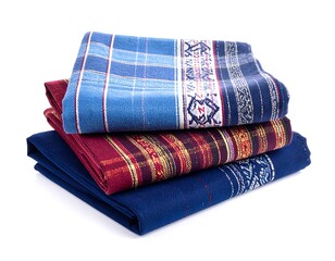 Stack of neatly folded, colorful woven textiles with intricate patterns and textures