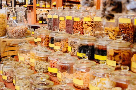 Bulk food store shelves with glass jars of dried fruits spices nuts, zero waste concept