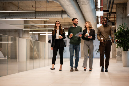 Diverse business team walking through modern office building