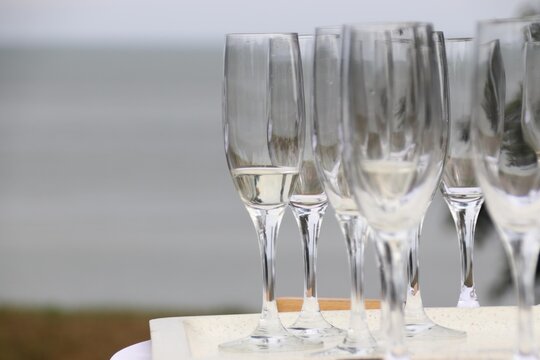 Glasses and sparkling wine on a white standing table on the beach create a festive atmosphere, Sylt, Keitum