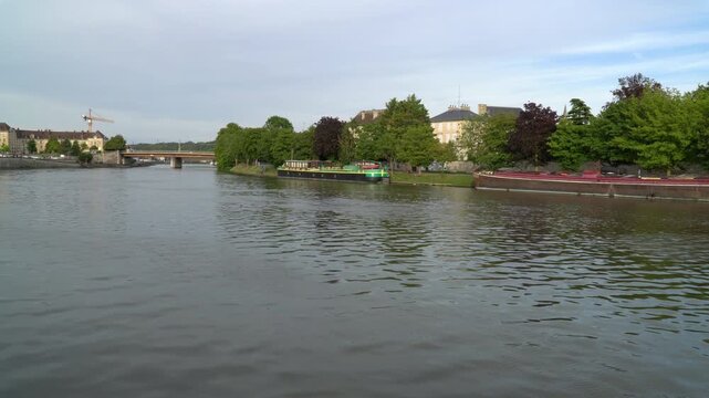 Waters of Oise river passing through the city of Creil, northern France.
