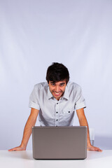 Happy businessman looking to his laptop