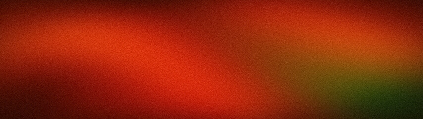 Fototapeta premium A wide, abstract grainy background featuring a dramatic blur of deep red, fiery orange, and dark forest green tones, creating a moody and atmospheric texture