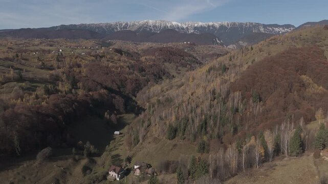 Stunning Autumn Pestera Village Valley under Snow Capped Piatra Craiului Mountains Aerial High Altitude Flight 4K Ungraded Log