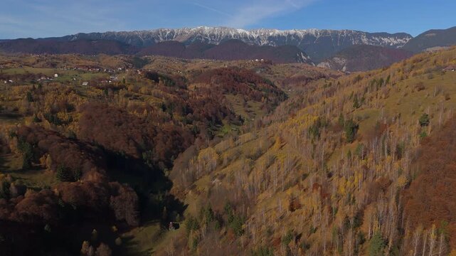 Majestic Late Autumn Pestera Valley and Snow-Capped Piatra Craiului Mountains Aerial Forward Ascending Shot 4K Graded