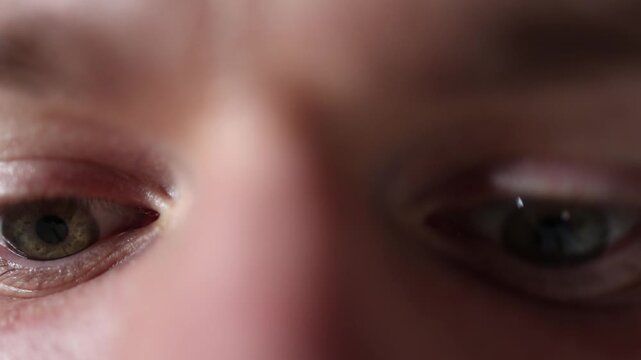 Closeup shows focused eyes scanning information with subtle micro movements as the gaze analyzes details creating a natural macro moment of concentration and data processing
