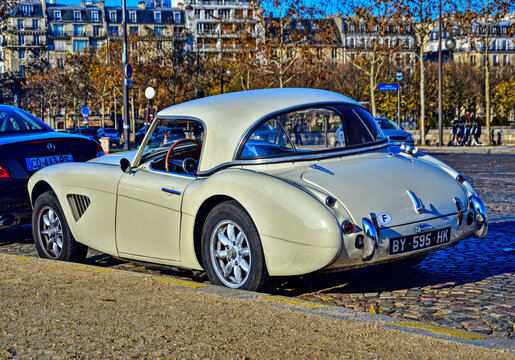 Paris, France - November 18th 2018 : Cream Austin Healey 100-6 (probably of 1958) parked on the street.  Each sunday, a car association organise an exhibition in front of the Invalides.