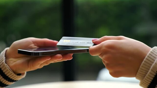 Contactless payment with credit card and smartphone outdoors