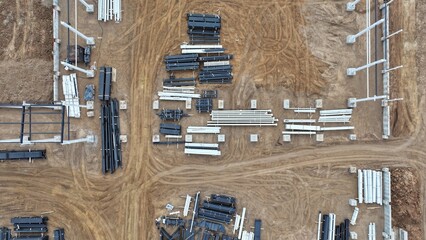 An outdoor warehouse of pipes (plastic and steel) of various sizes and diameters at a construction site. Aerial view of outdoor pipe storage. © Aerial Drone Master
