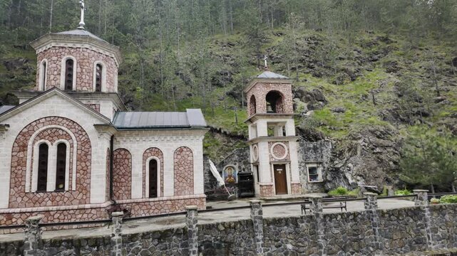 Orthodox church in Bele Vode near Mokra Gora surrounded by forested mountain landscape in spring. Scenic rural Serbia travel and spiritual heritage concept