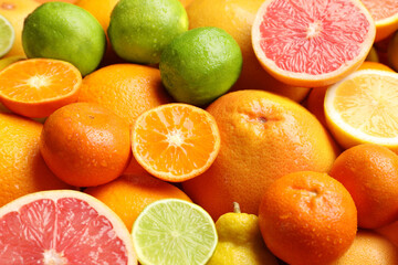 Fresh ripe citrus fruits as background, closeup