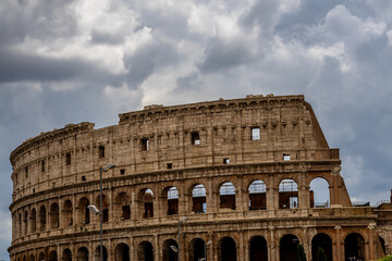 Fototapeta premium Famous tourist attraction of historic Colosseum amphitheatre with ancient stone arches in Rome Italy