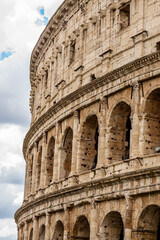 Fototapeta premium Famous tourist attraction of historic Colosseum amphitheatre with ancient stone arches in Rome Italy