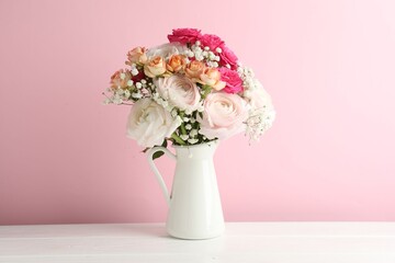 Bouquet of beautiful flowers on white wooden table