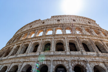 Fototapeta premium Famous tourist attraction of historic Colosseum amphitheatre with ancient stone arches in Rome Italy