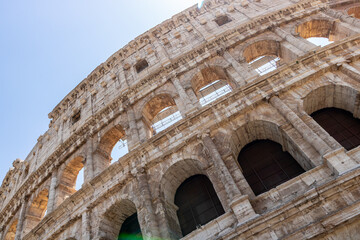 Fototapeta premium Famous tourist attraction of historic Colosseum amphitheatre with ancient stone arches in Rome Italy
