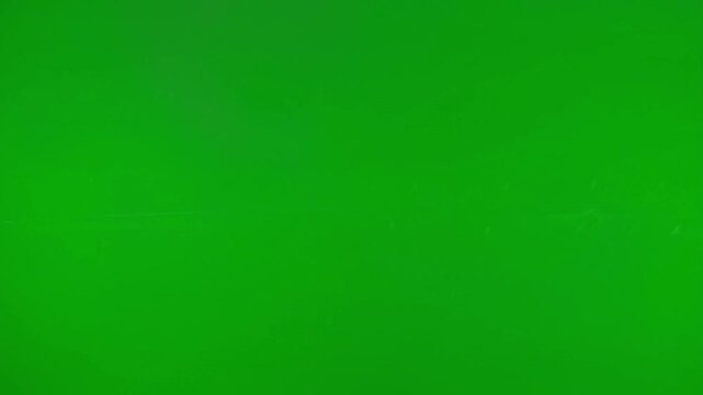 Green background in solid color with bright lighting on flat texture for graphic design