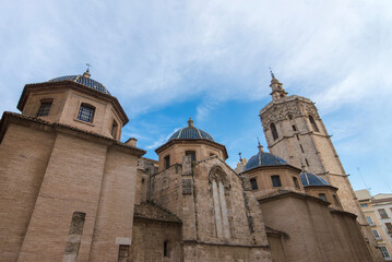 Ancient stone cathedral with blue tiled domes and bell tower © Sergey