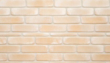 Fototapeta premium A textured beige brick wall background, creating a warm and inviting aesthetic for various design projects