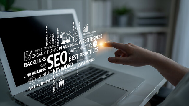 A focused hand points towards a laptop screen filled with essential SEO concepts. Explore digital marketing strategies and techniques for effective online presence and success. Tessel