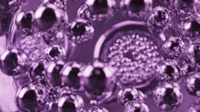 Abstract closeup of purple liquid with bubbles and small particles creating a mesmerizing and intriguing background suitable for various creative projects