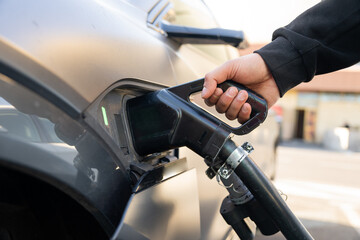 Electric vehicle connected to a charging station, symbolizing sustainable transportation, clean energy innovation, and the future of eco-friendly mobility.