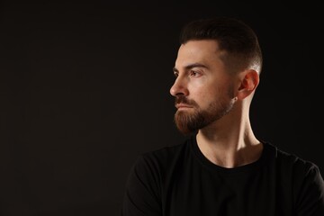Fototapeta premium Bearded man on black background. Space for text