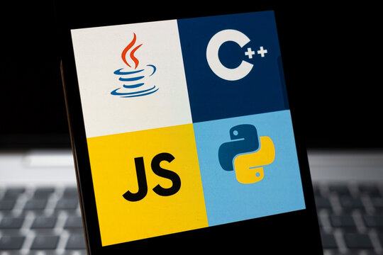 Warsaw, Poland - Feb 24, 2026: Close-up of popular programming languages icons including Java, C++, JavaScript, and Python on smartphone screen against blurred laptop background.