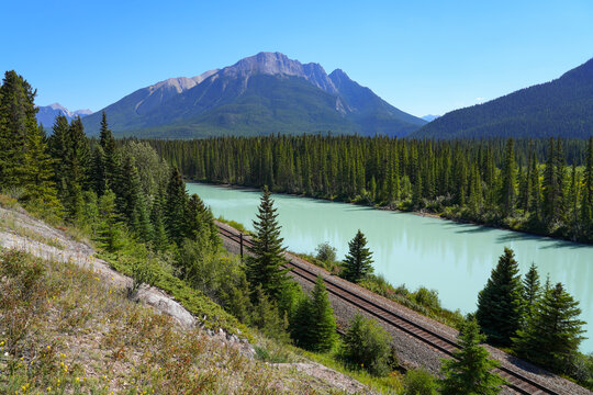 Railway track on the banks of the Bow River in Banff National Park, Alberta, Canada