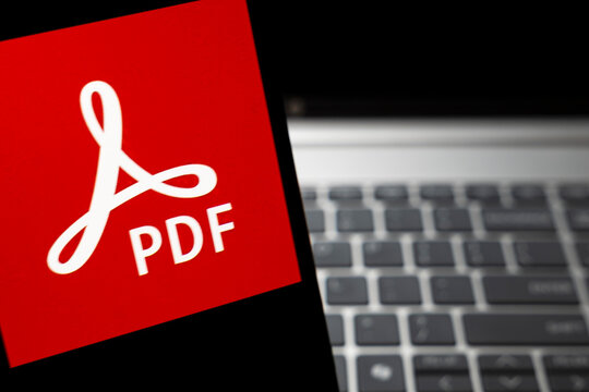 Warsaw, Poland - Feb 24, 2026: Close-up of Adobe PDF logo on smartphone screen, highlighting digital document format and its usability in modern digital workflows.