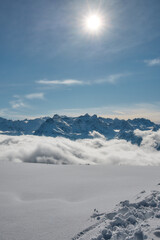 Sun above snowy alpine landscape, Stoos Switzerland