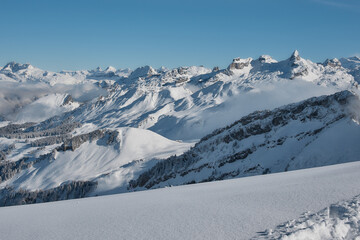 Snowy alpine peaks under clear blue sky, Stoos Switzerland