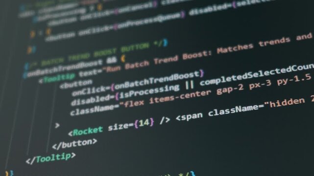 A close-up shot of colorful programming code scrolling down a dark computer screen. Concept of software development, web design, coding, hacking, and modern technology.