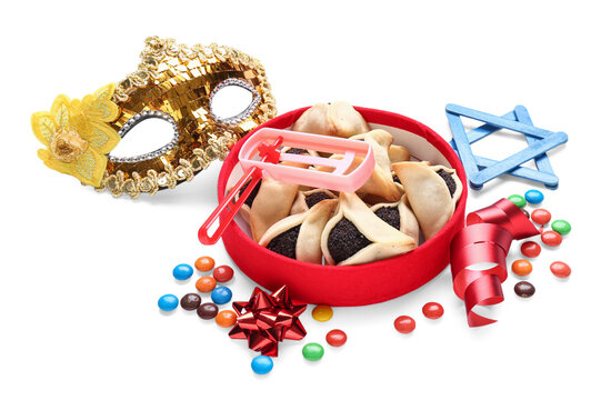 Plate with tasty hamantaschen, festival mask, rattle and candies on white background. Purim celebration