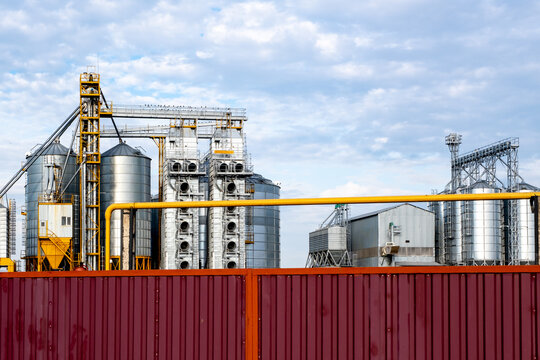 A large modern plant for the storage and processing of grain crops. Agro-processing manufacturing plant for processing drying cleaning and storage of agricultural products. Export of grain by railway