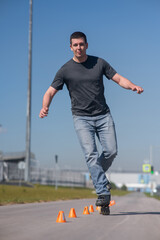 A Caucasian man rollerblades around the slalom course.