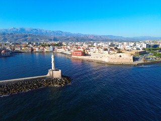 Obraz premium bay of Chania with sea and lighthouse at sunny summer sunset, Crete, Greece,