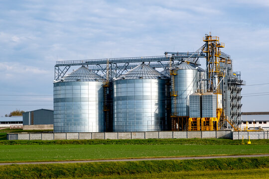 A large modern plant for the storage and processing of grain crops. Agro-processing manufacturing plant for processing drying cleaning and storage of agricultural products. Export of grain by railway