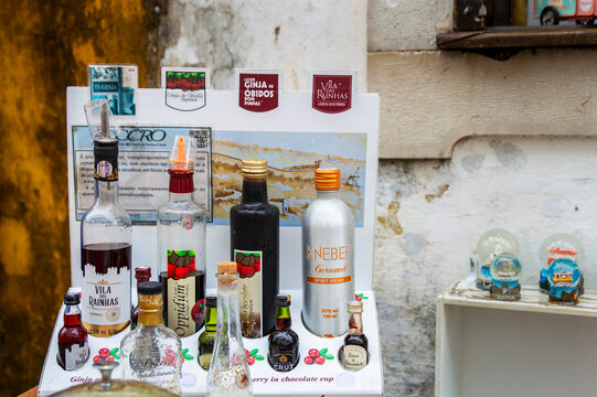 Obidos, Portugal, March 8, 2025. View of colourful bottles for famous &ldquo;ginja de &Oacute;bidos,&rdquo; or &ldquo;ginjinha&rdquo;, the cherry liqueur at the historic town Obidos.