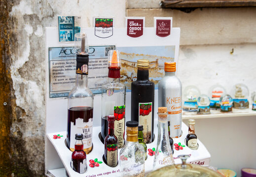 Obidos, Portugal, March 8, 2025. View of colourful bottles for famous &ldquo;ginja de &Oacute;bidos,&rdquo; or &ldquo;ginjinha&rdquo;, the cherry liqueur at the historic town Obidos.