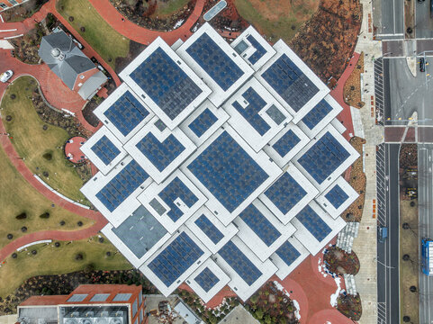 Aerial view of futuristic solar panels on the Johns Hopkins University Bloomberg student center roof, forming interesting geometric shapes