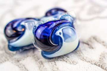 Close-up of laundry detergent pods on soft towel.