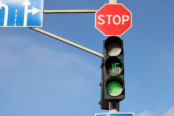 View of green traffic lights with timer in city
