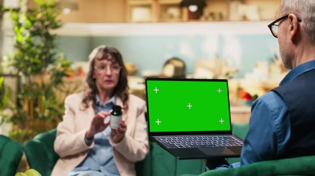 Isolated chroma key, aged woman, laptop in living room, retirement age, senior husband and wife enjoying quiet free time together. Old couple ensuring daily care with medicine for wellness.